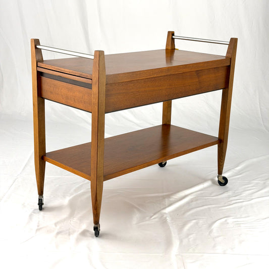 Wooden serving cart with two shelves on a white background