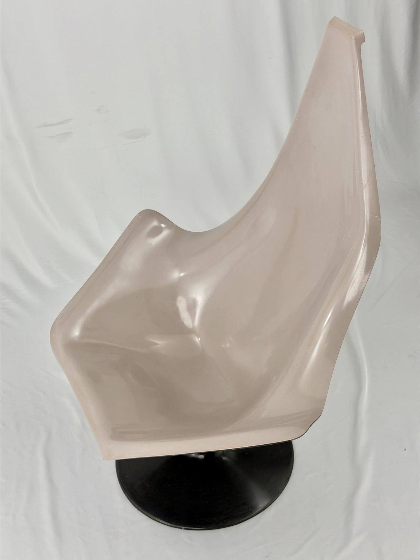 Space Age fiberglass chair with a grey shell and black base on a white background