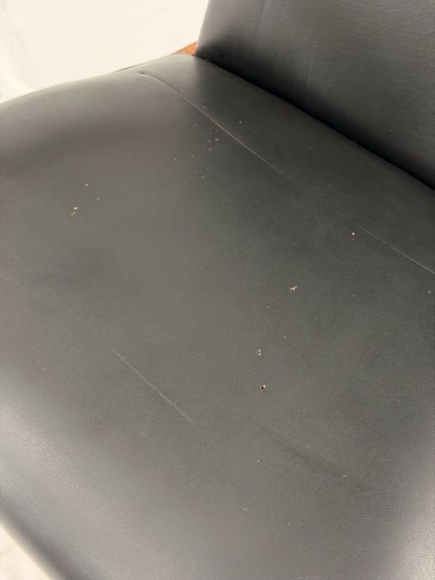 Black leather seat with visible wear