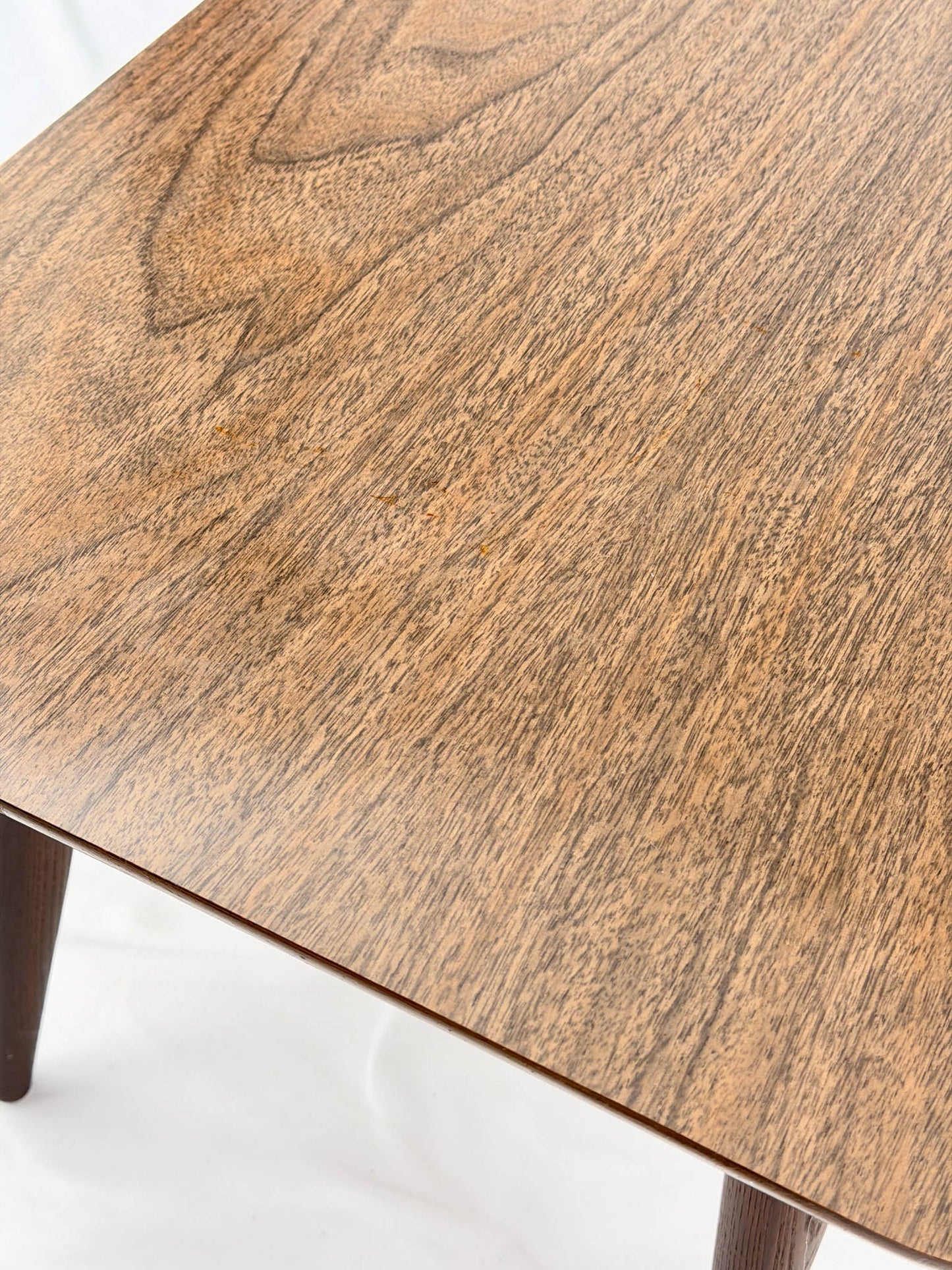 Close-up of a wooden table with a white background
