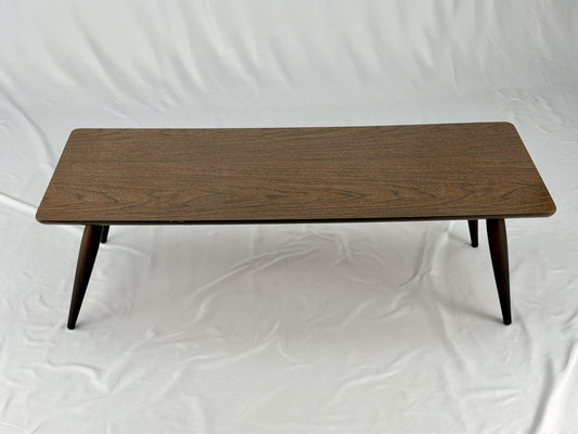 Wooden coffee table with four legs on a white background
