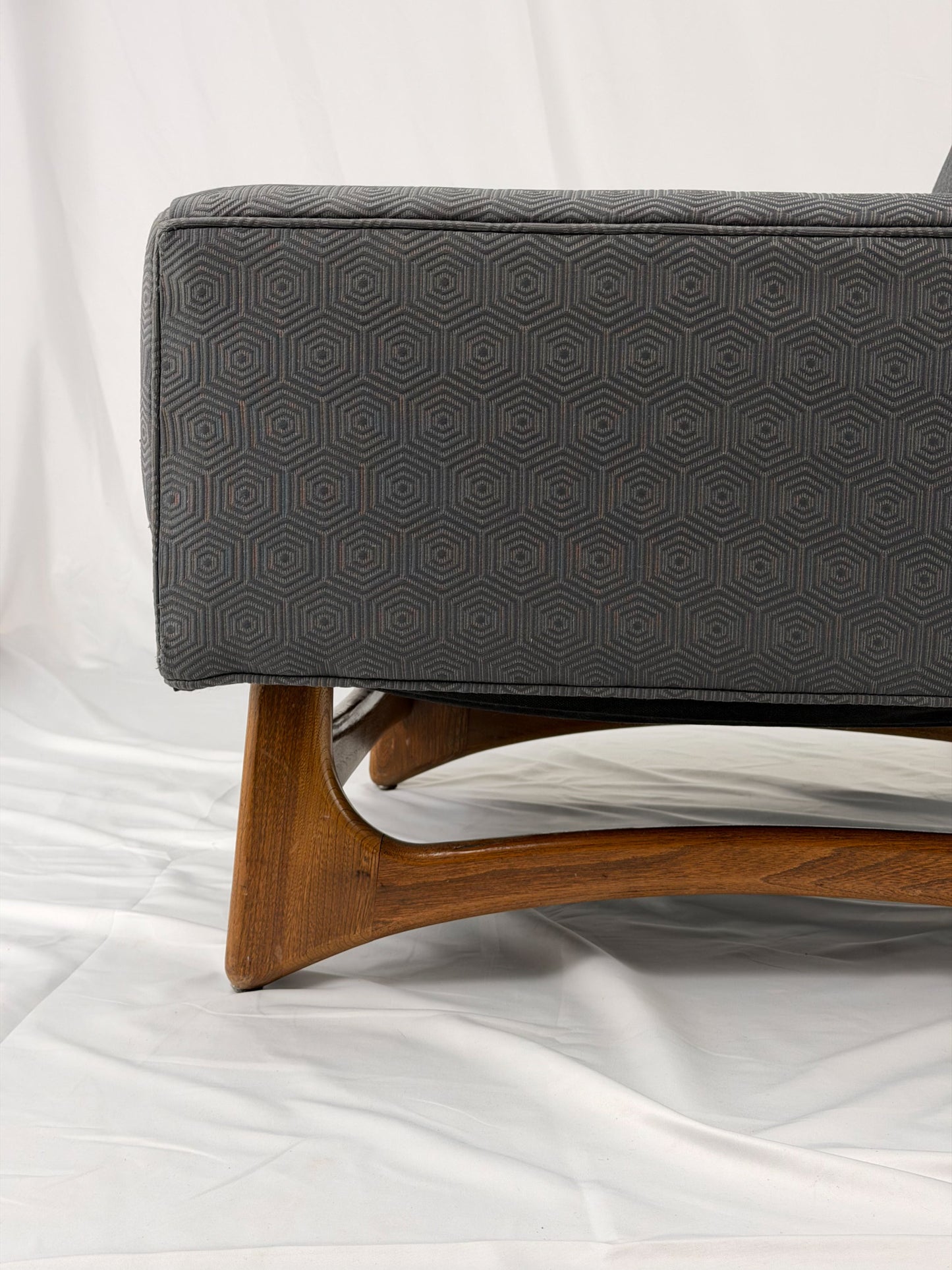 Gray armchair with wooden legs on a white background