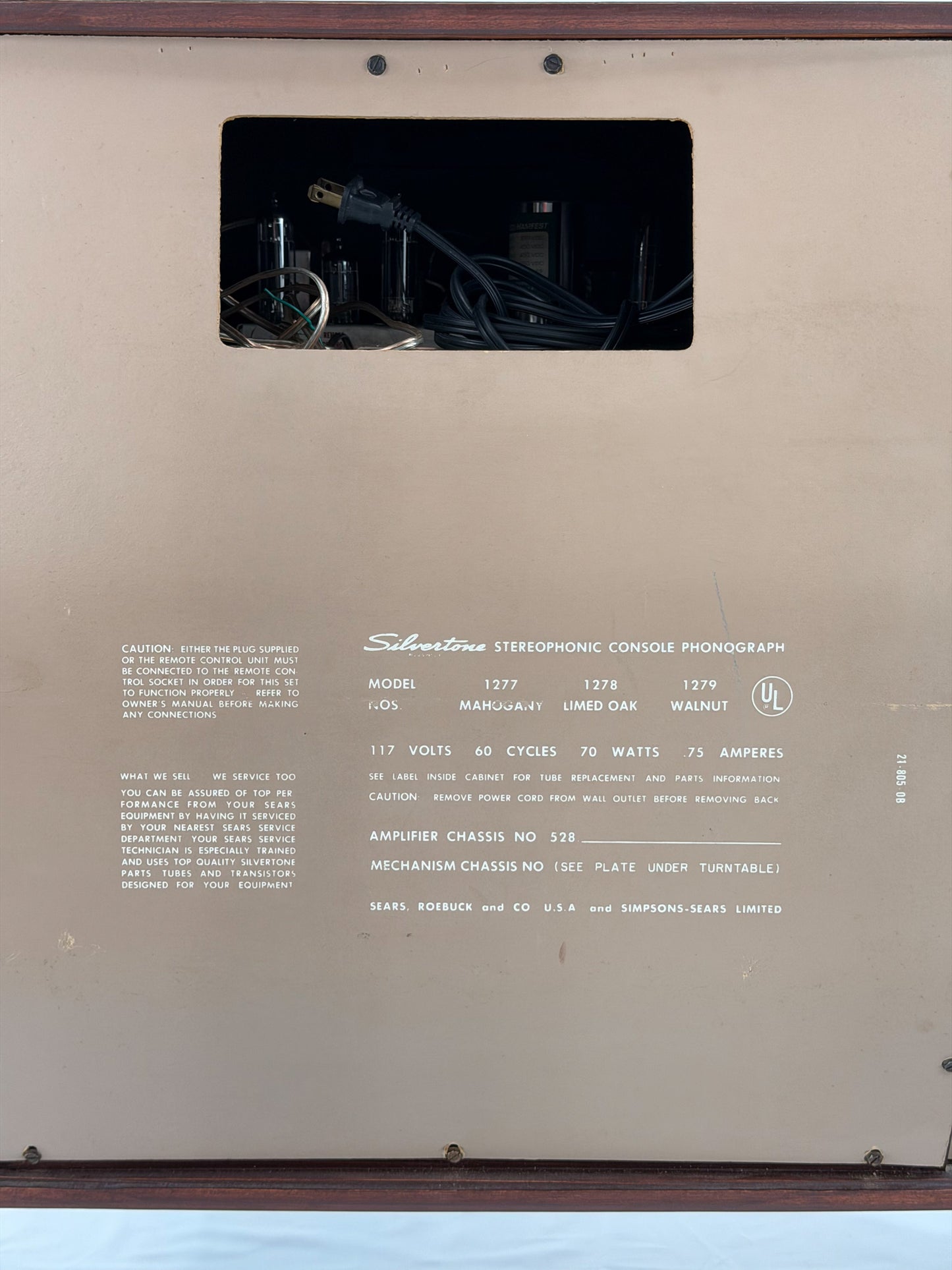 Back panel of a vintage stereo console with model and specifications printed on it.