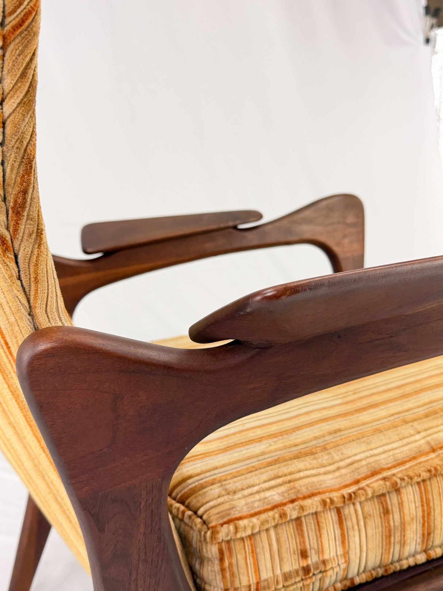 Adrian Pearsall armchair with striped upholstery on a white background
