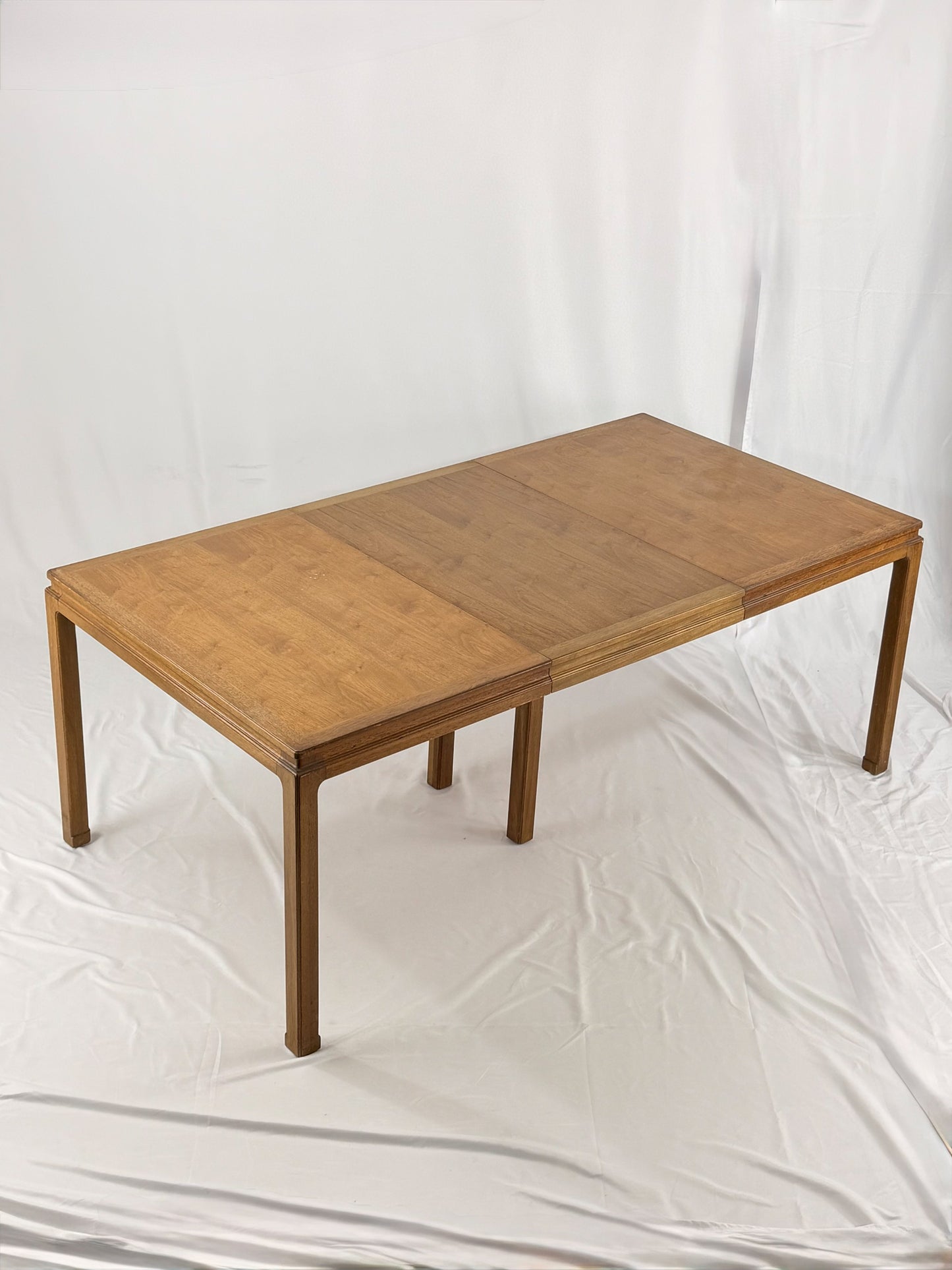 Wooden dining table with one extension on a white background
