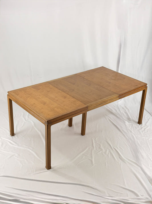 Wooden dining table with one extension on a white background