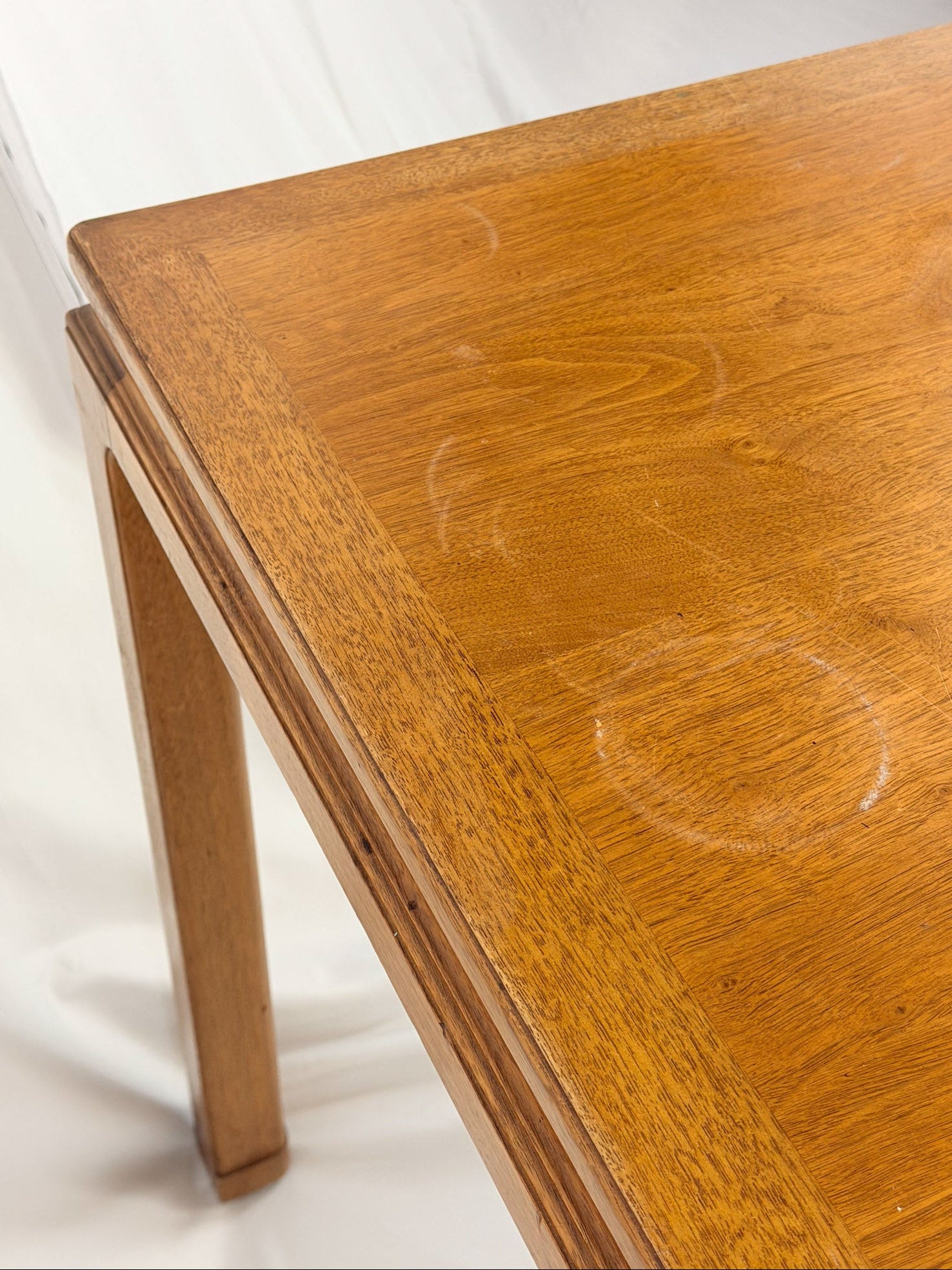 Wooden table with visible scratches on a white background