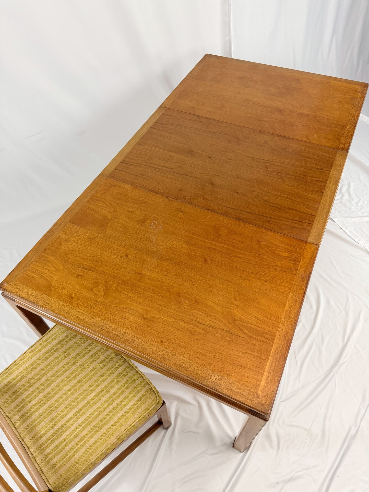 Wooden table with a chair on a white background