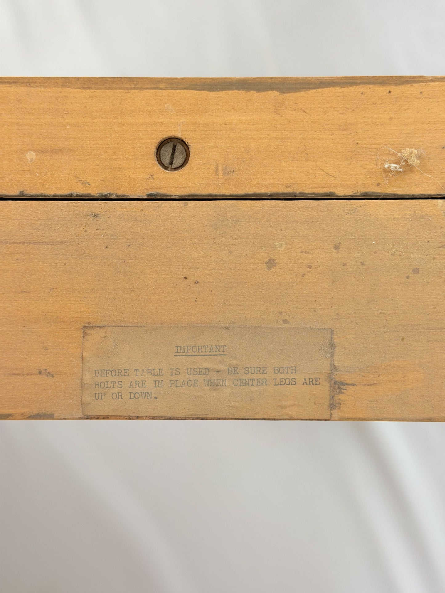 Wooden dining table with makers mark  on a white background