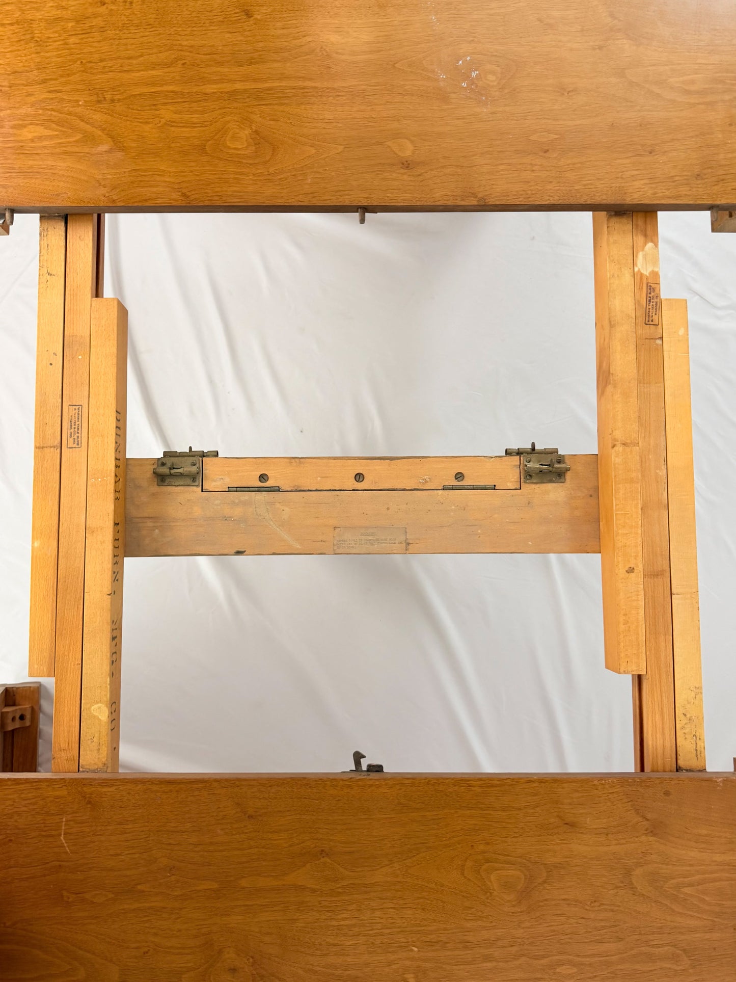 Wooden drafting table with a white backdrop