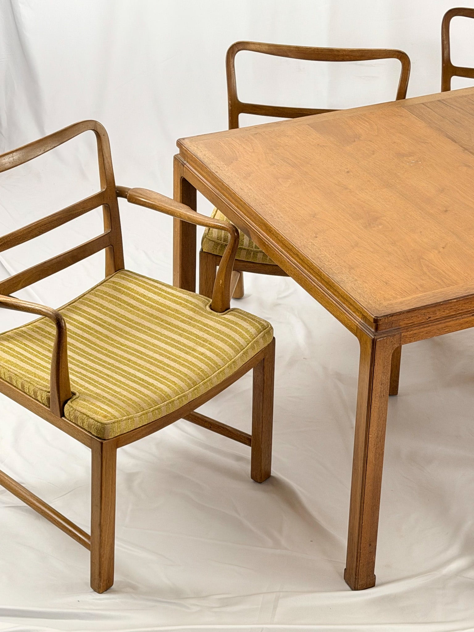 Wooden dining table with chairs on a white background