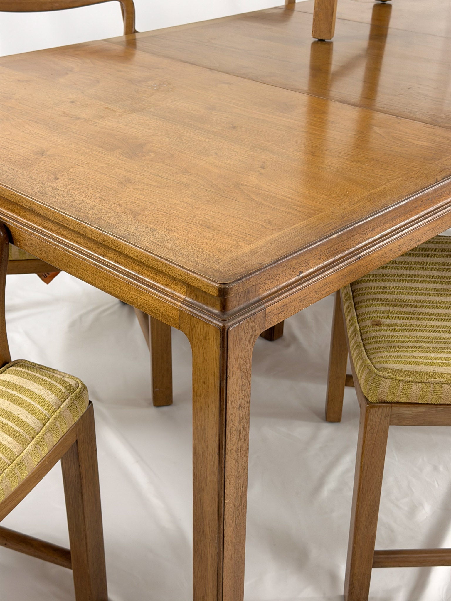 Wooden dining table with chairs on a white background