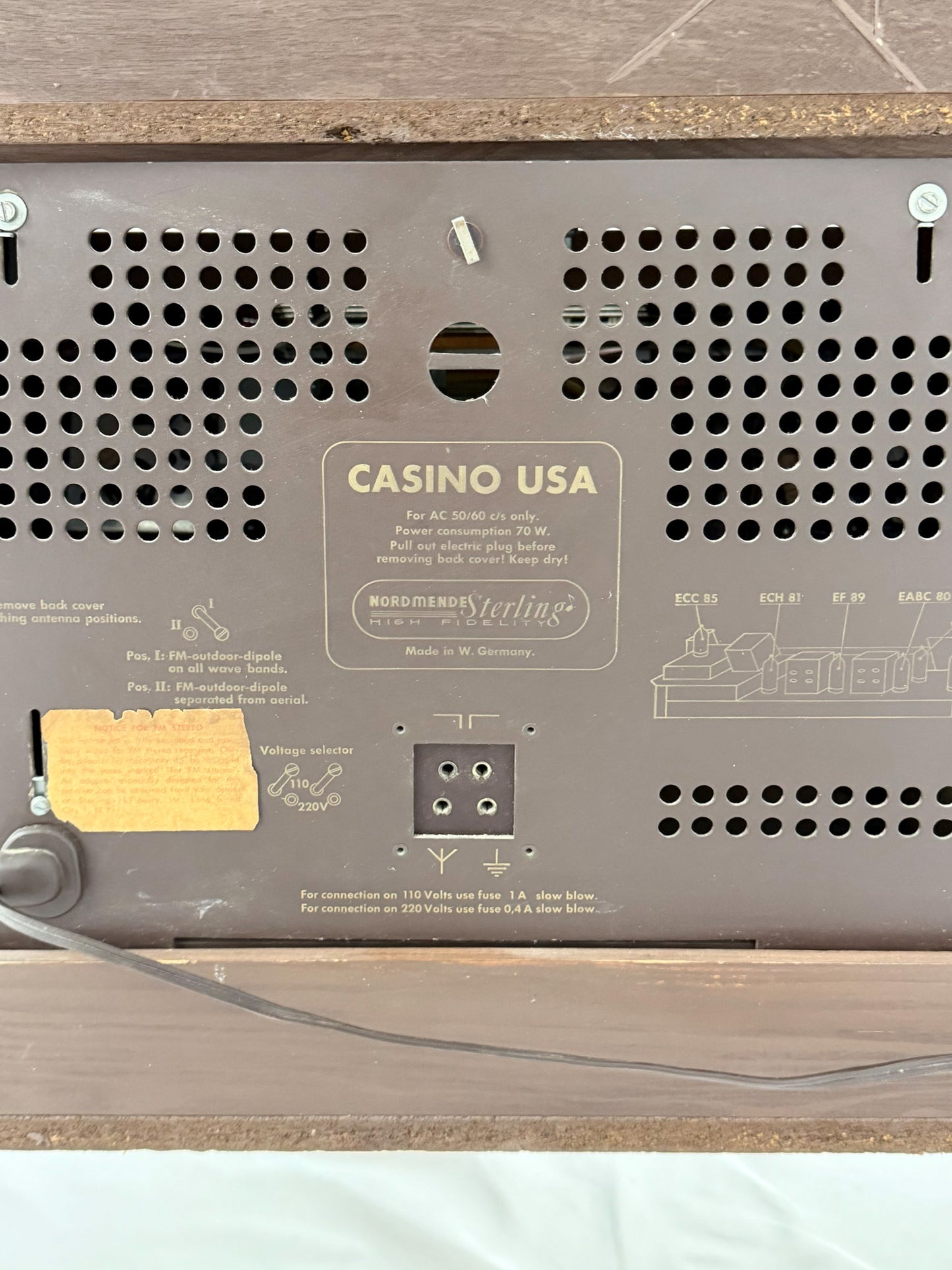 Back panel of a device with 'Casino USA' branding on a wooden surface.