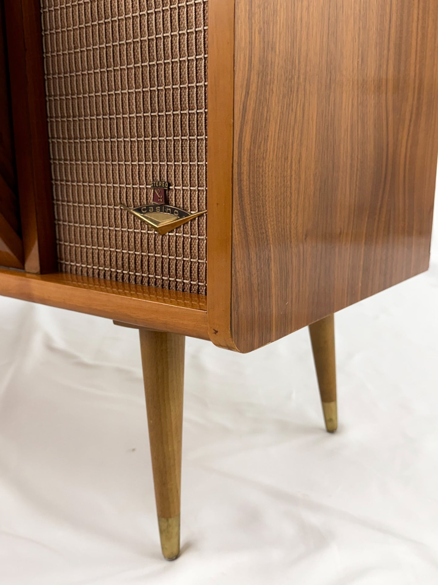 Vintage record player with a turntable and control panel on a wooden surface.