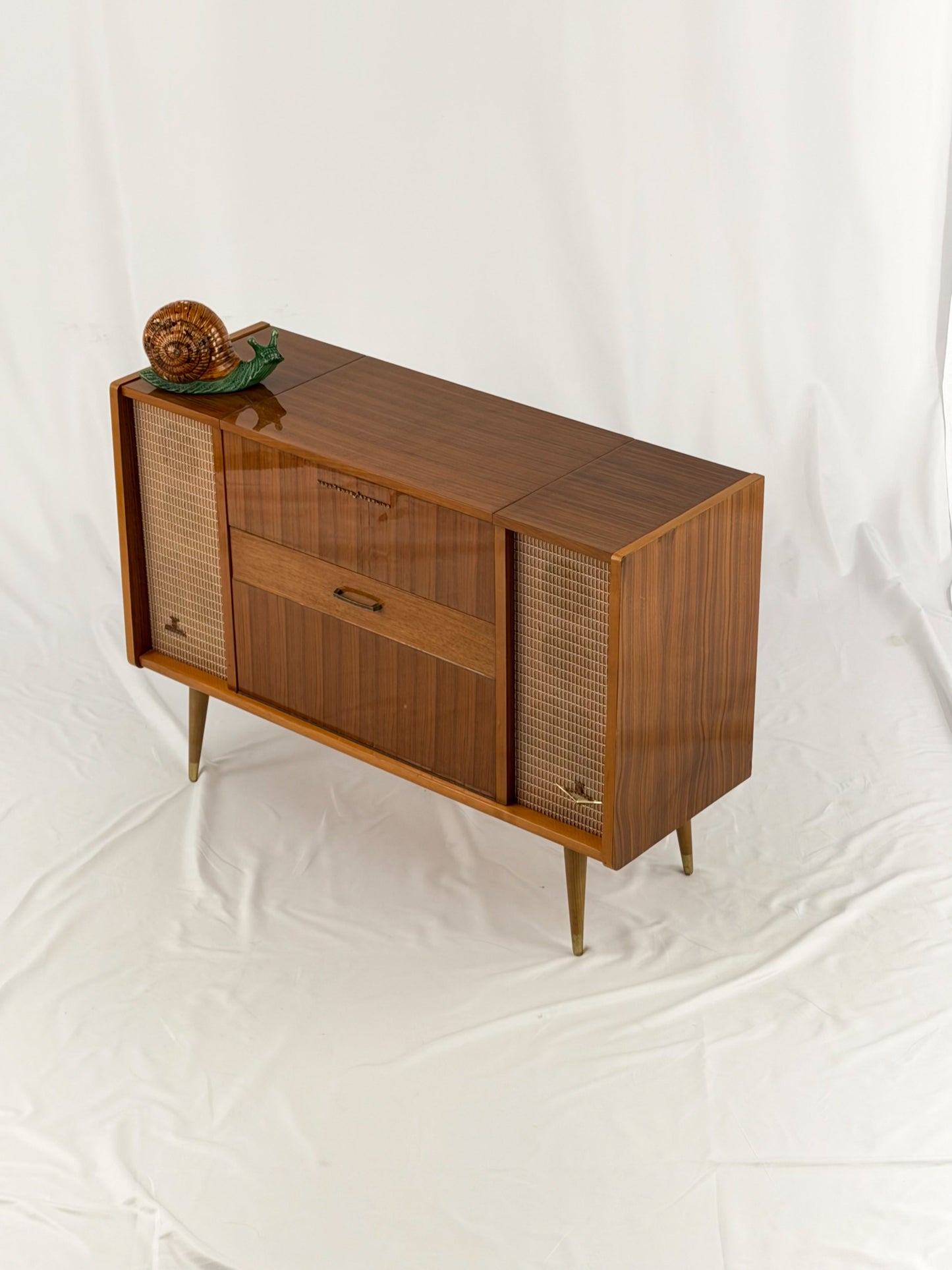 Vintage record player with a turntable and control panel on a wooden surface.