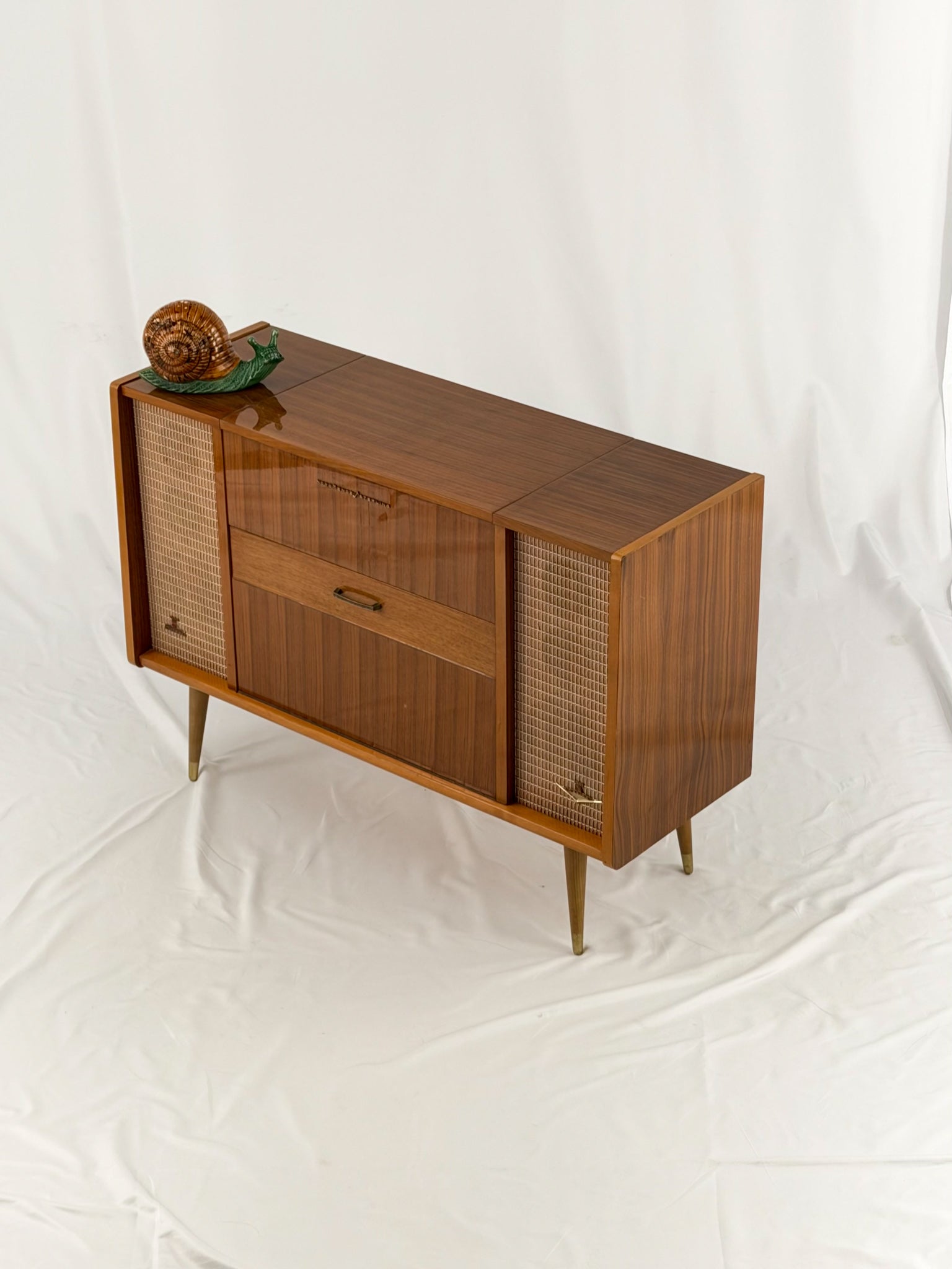 Vintage record player with a turntable and control panel on a wooden surface.