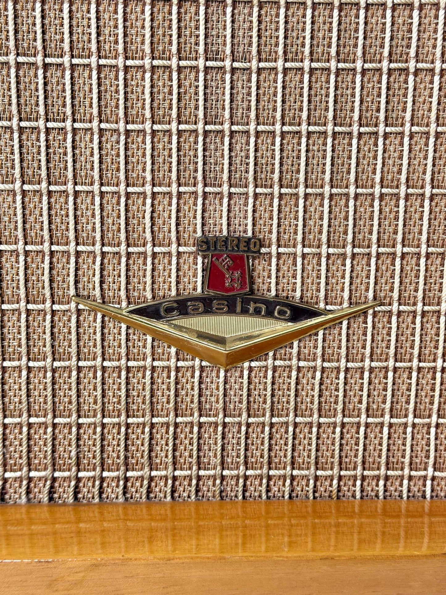 Vintage radio with a logo on a textured fabric background