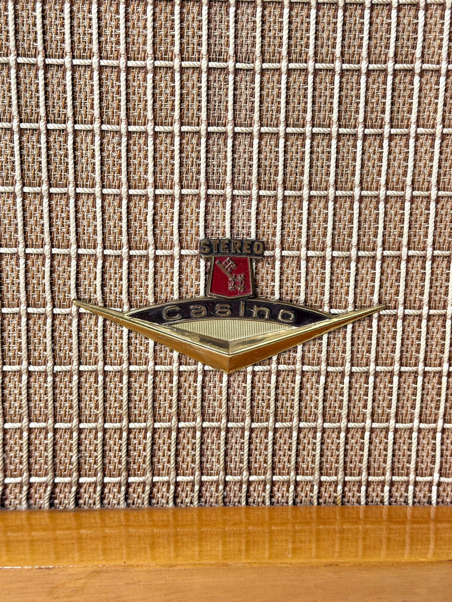 Vintage radio with a logo on a textured fabric background