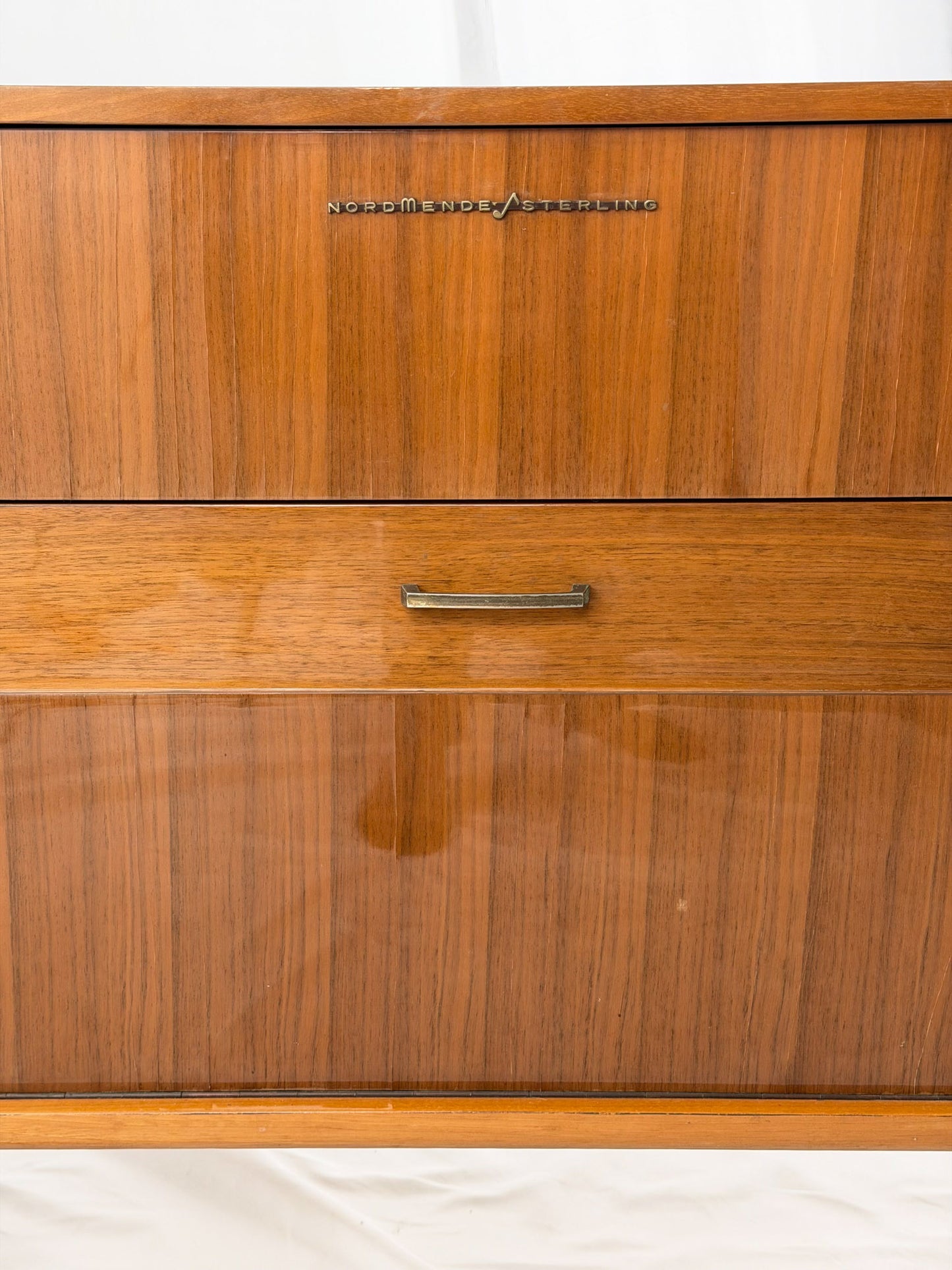 Vintage record player with a turntable and control panel on a wooden surface.