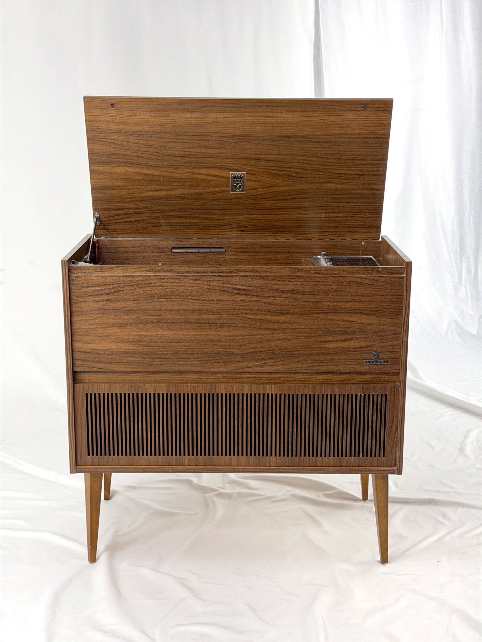 Vintage wooden stereo console on a white background