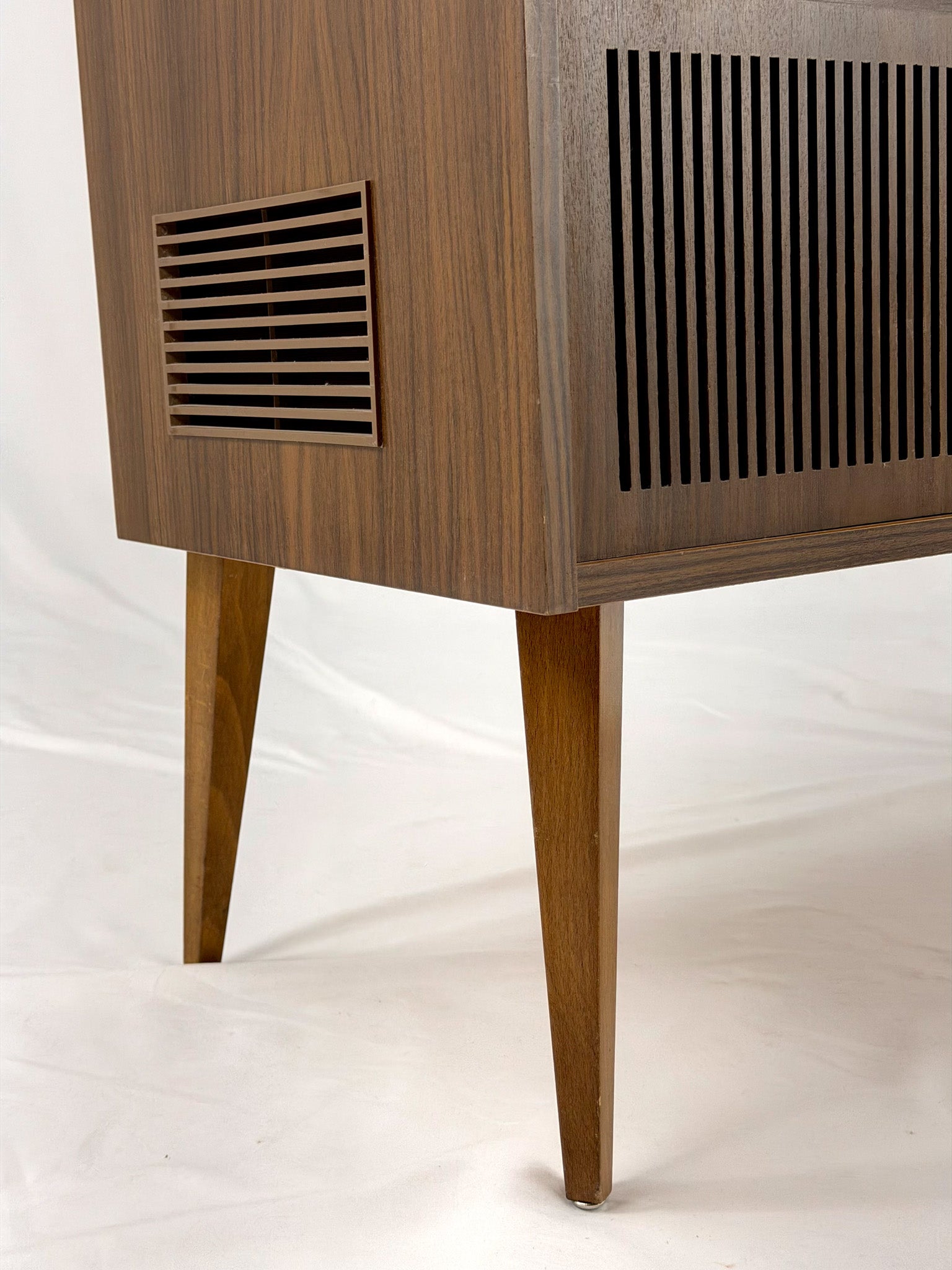 Vintage wooden stereo console on a white background