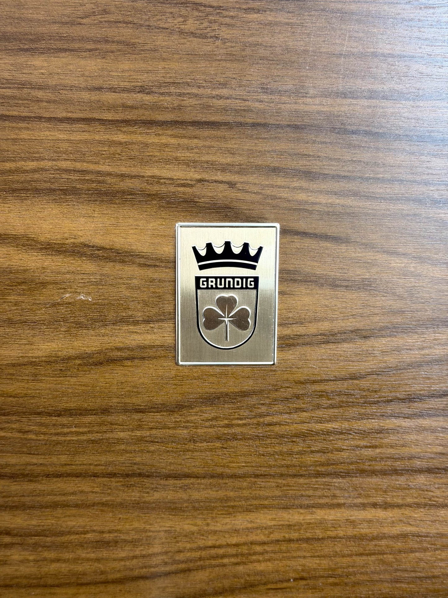 Grundig logo on a wooden surface