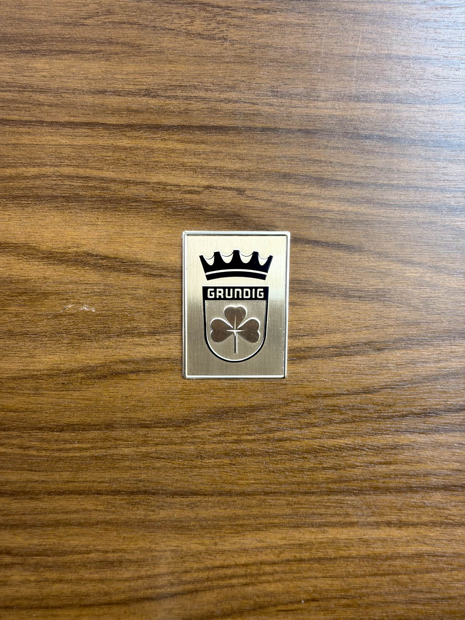 Grundig logo on a wooden surface