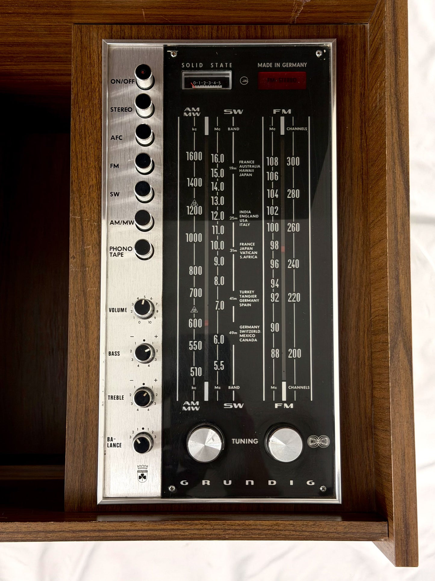 Vintage Rundig radio receiver with wooden frame on a white background