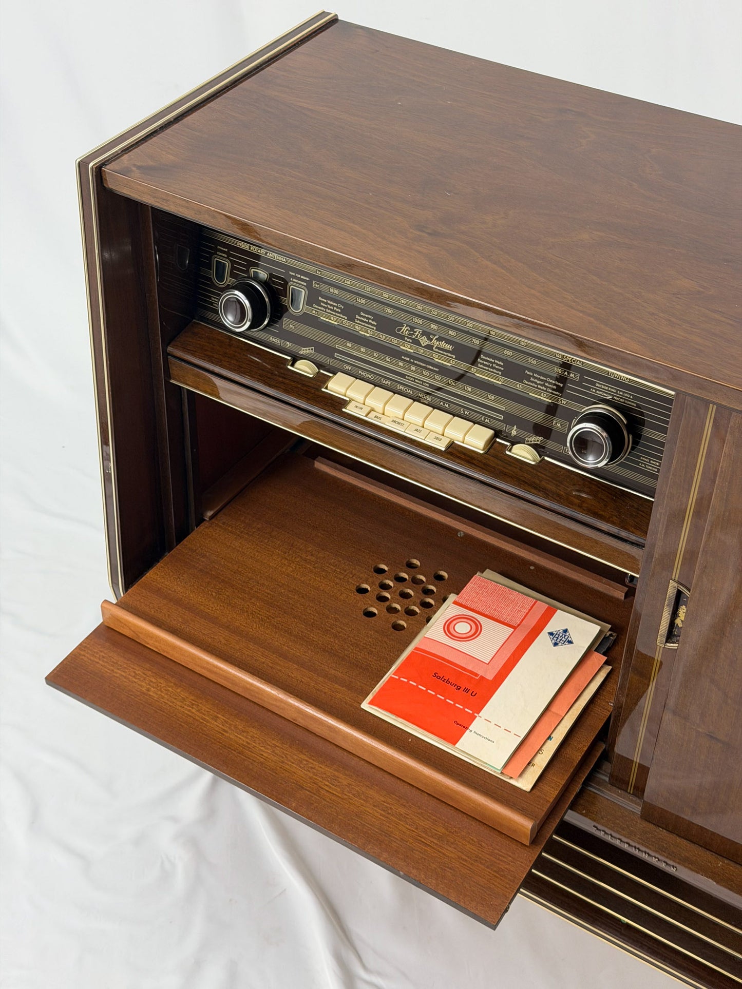 Vintage wooden stereo console on a white background