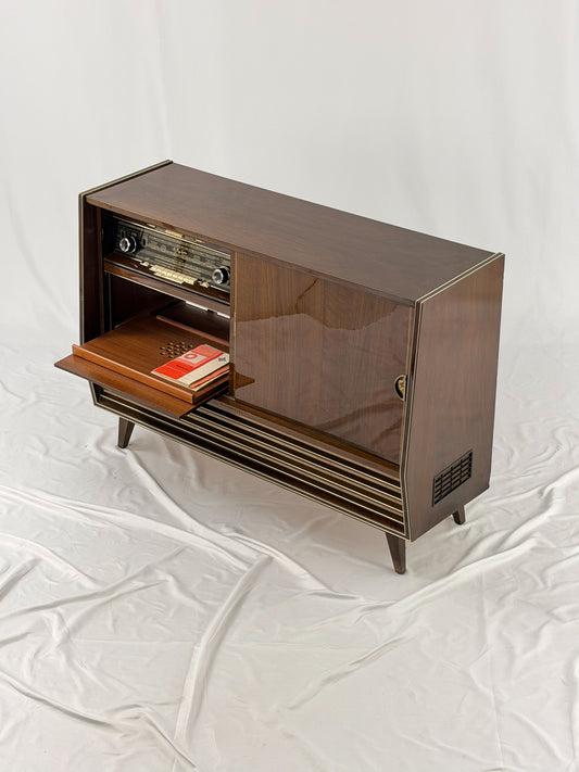 Vintage wooden stereo console on a white background