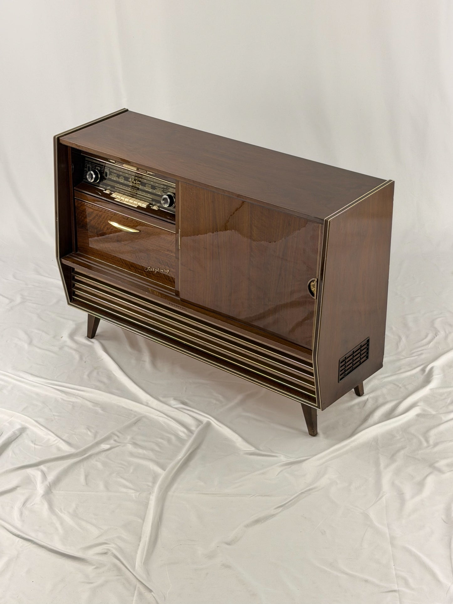 Vintage wooden stereo console on a white background