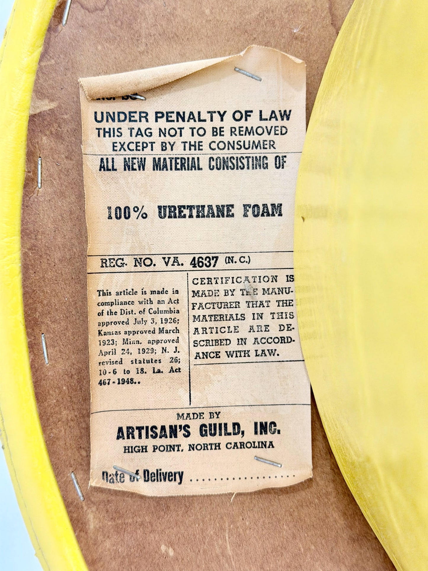 Vintage-style label on a yellow rim with text about urethane foam and Artisan's Guild, Inc.