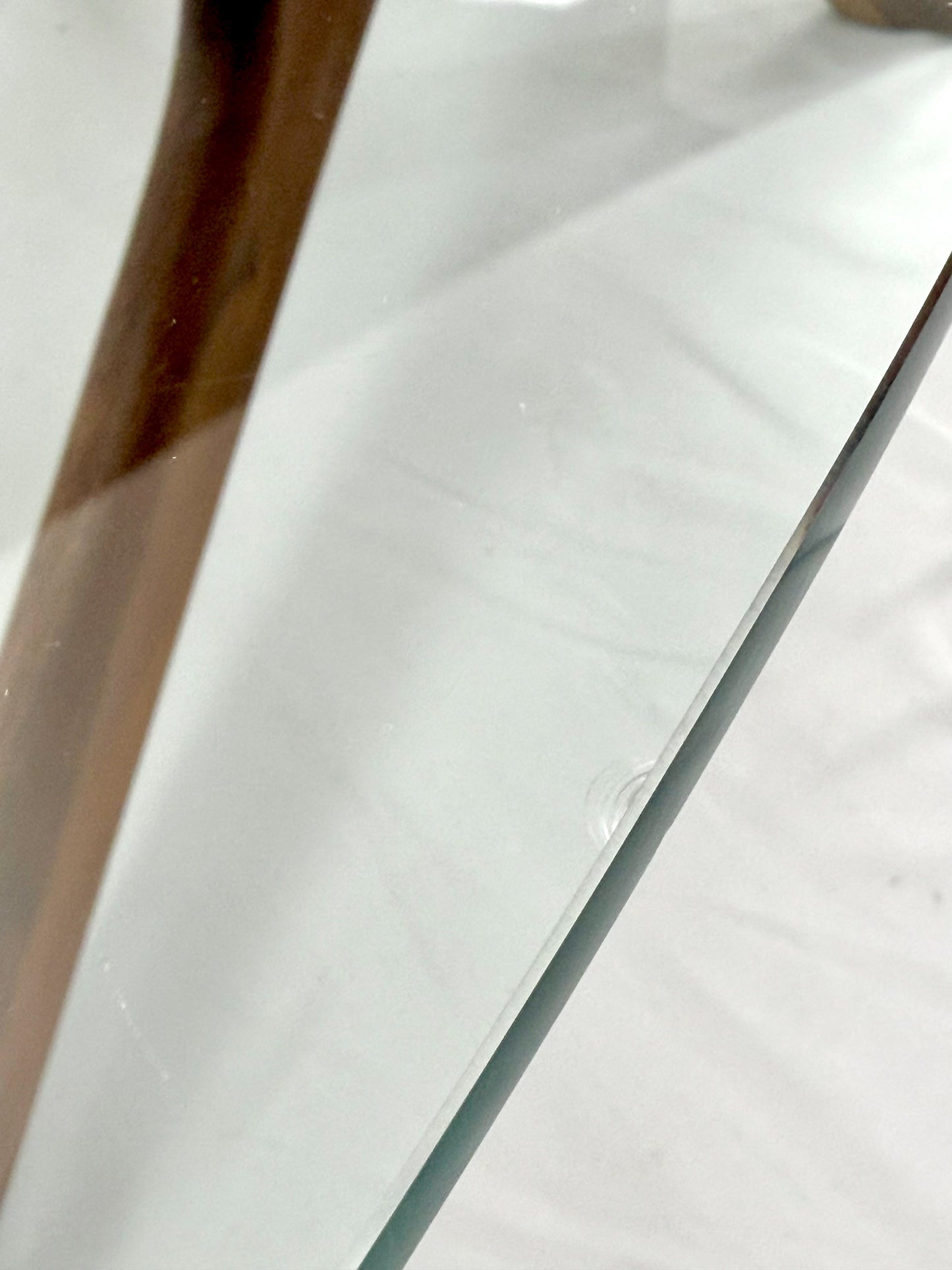 Close-up of a clear glass panel with a wooden frame.