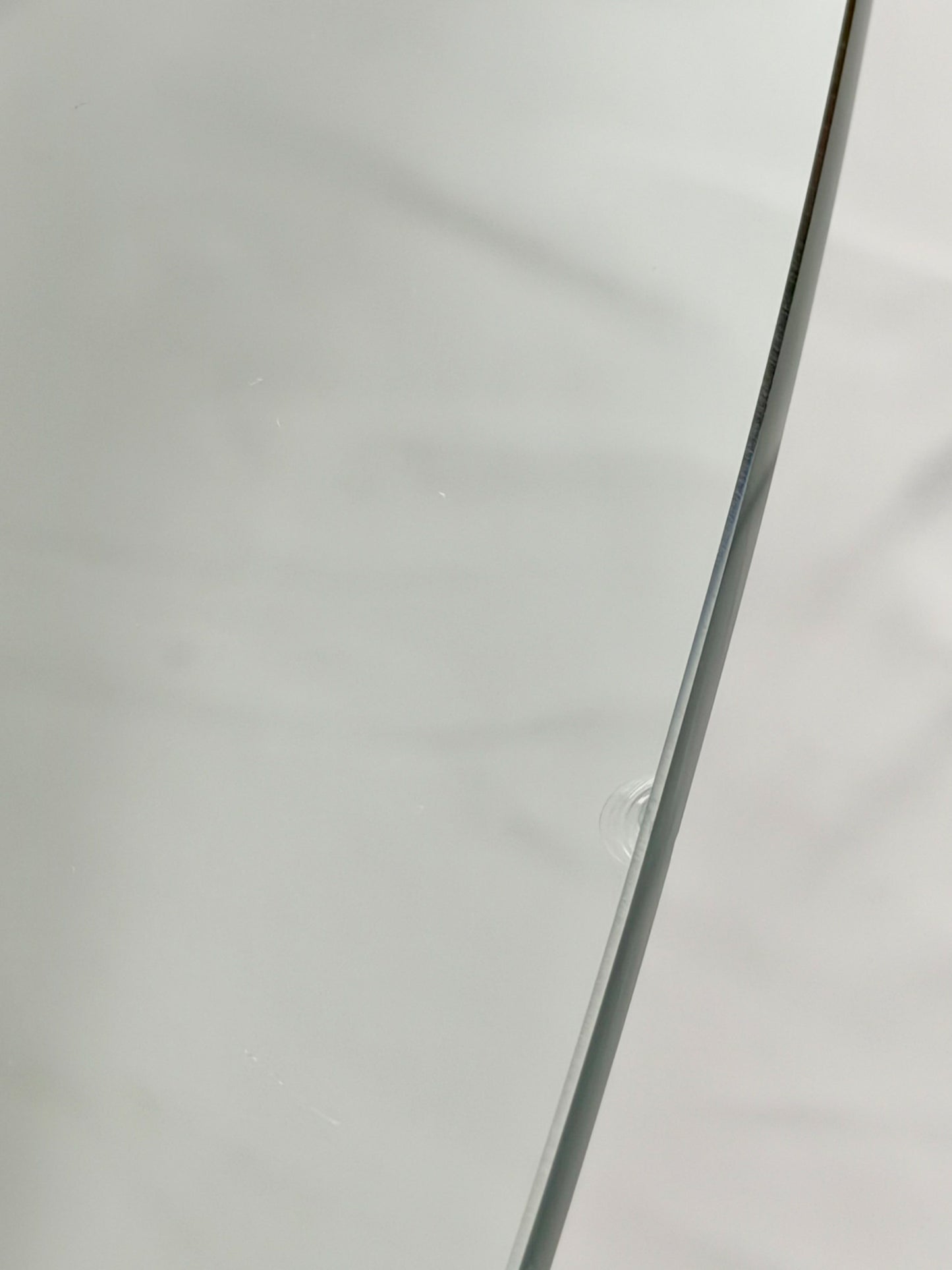Glass-top table with wooden base on a white background