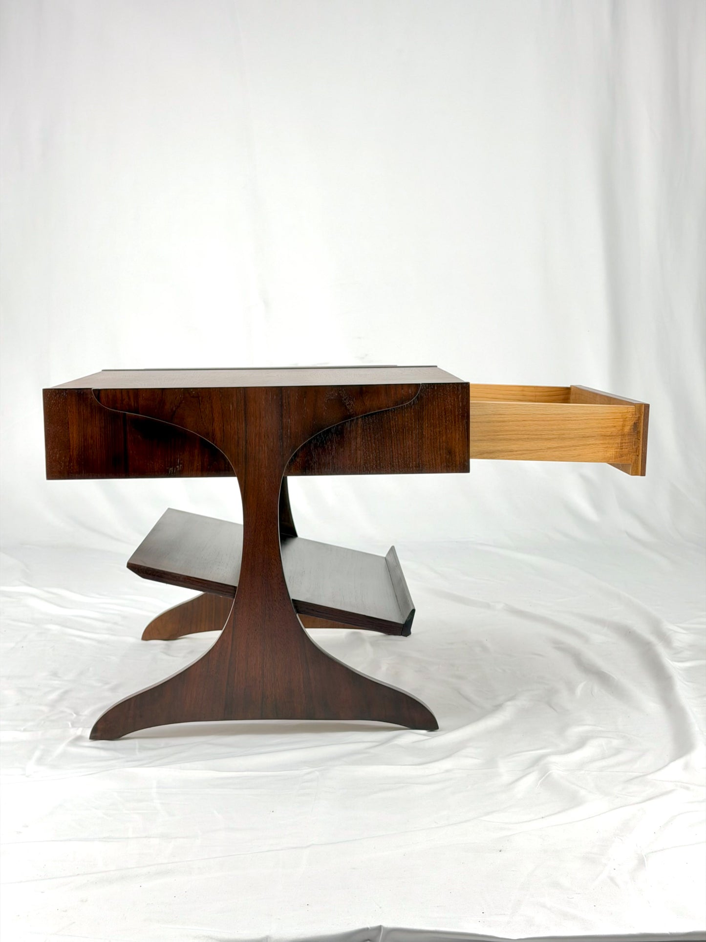 Wooden side table with a unique design on a white background