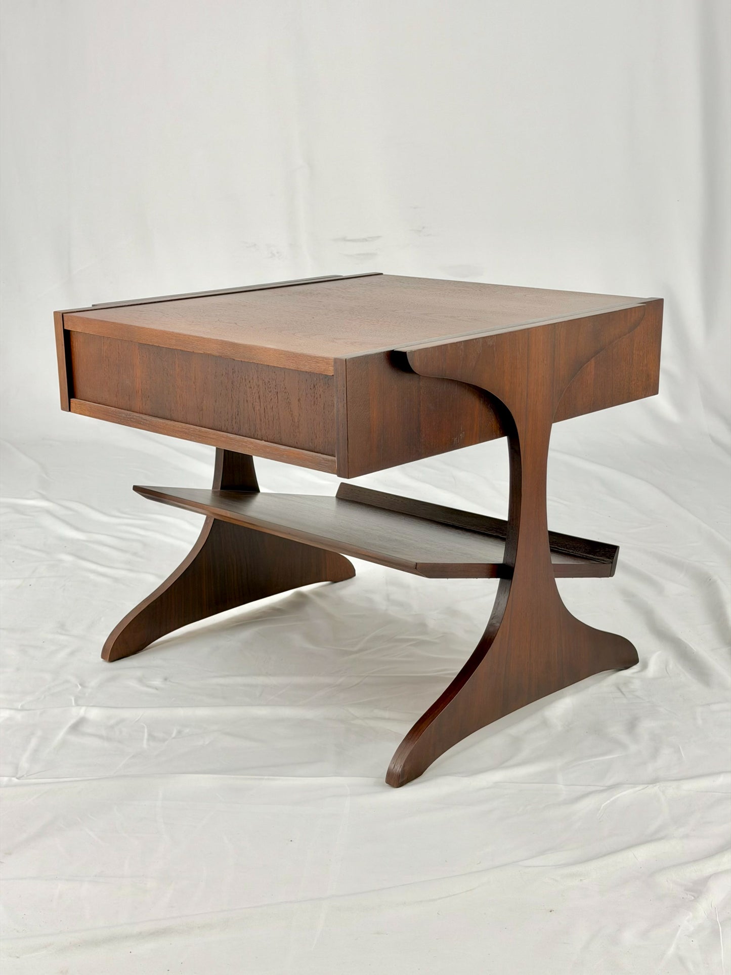 Wooden side table with drawers on a white background