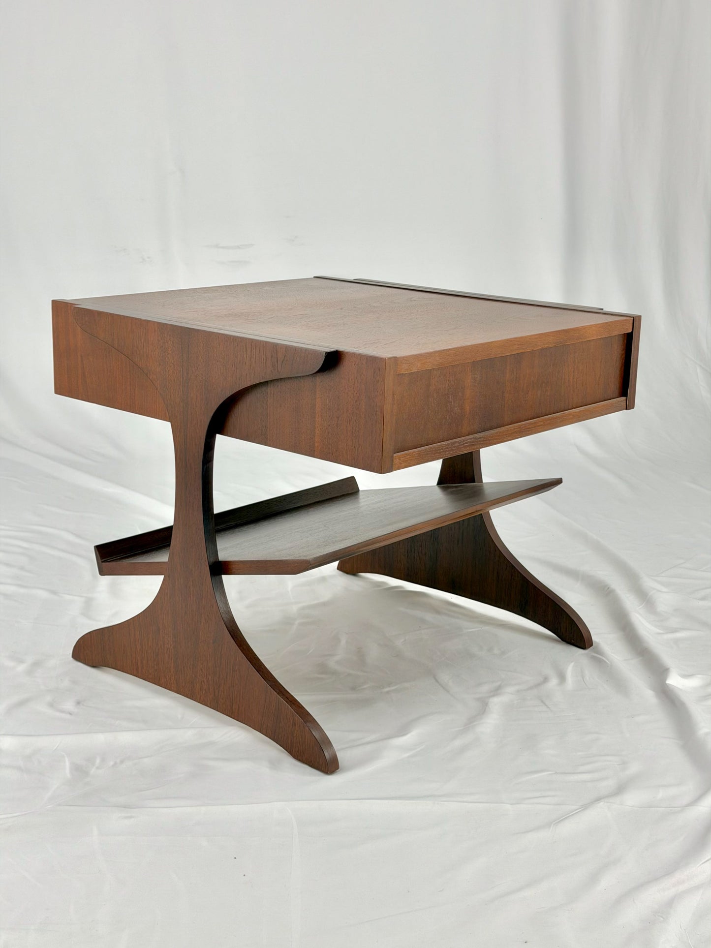 Wooden side table with a unique design on a white background