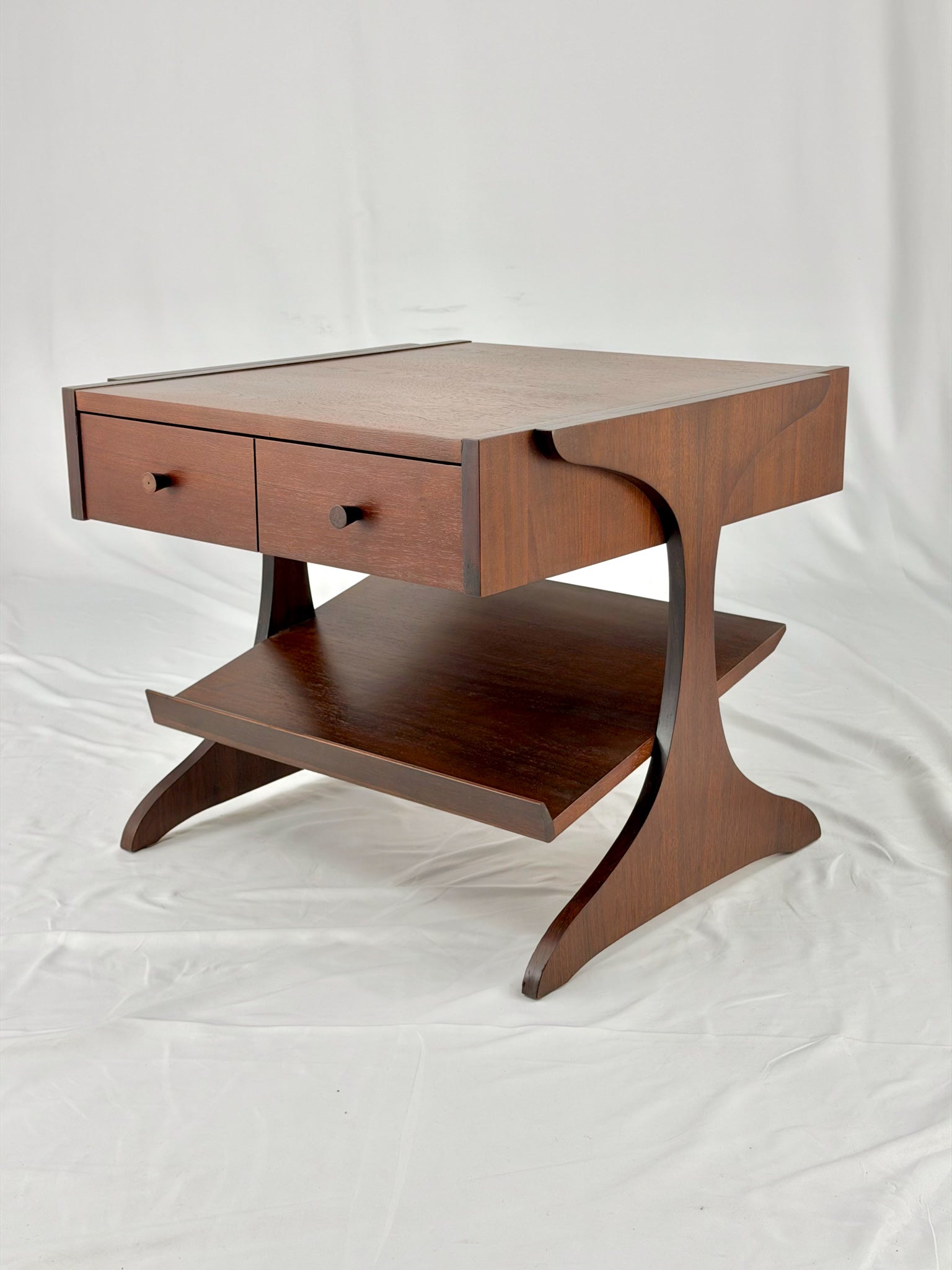 Wooden side table with drawers on a white background