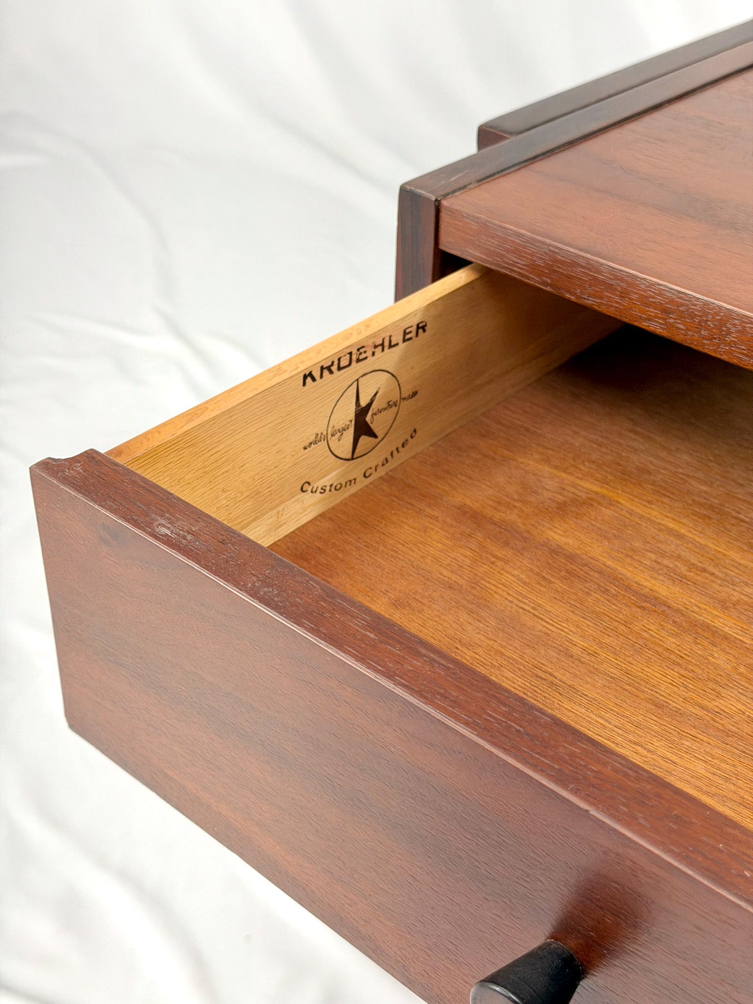 Wooden side table with drawers on a white background