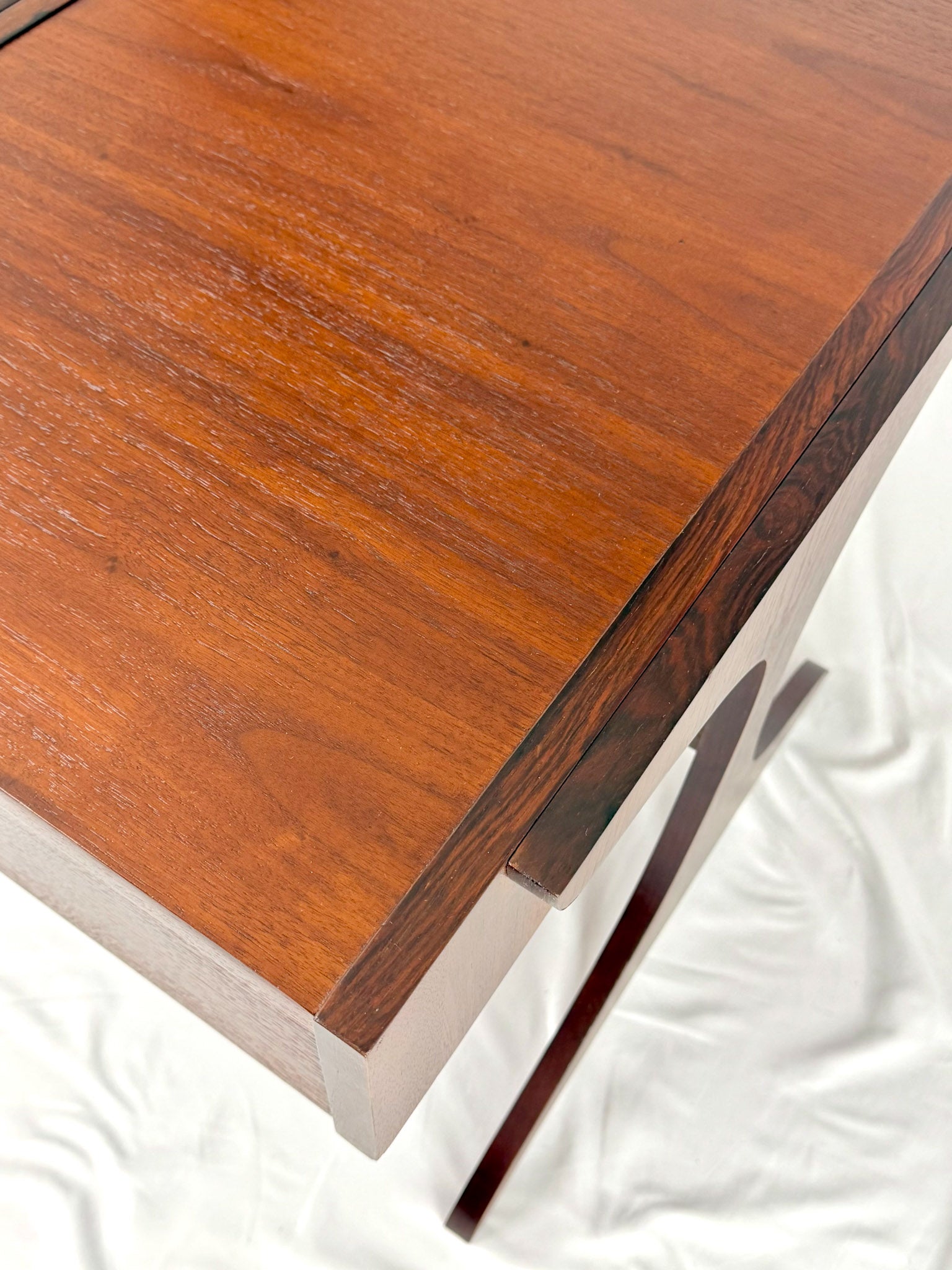 Wooden side table with drawers on a white background