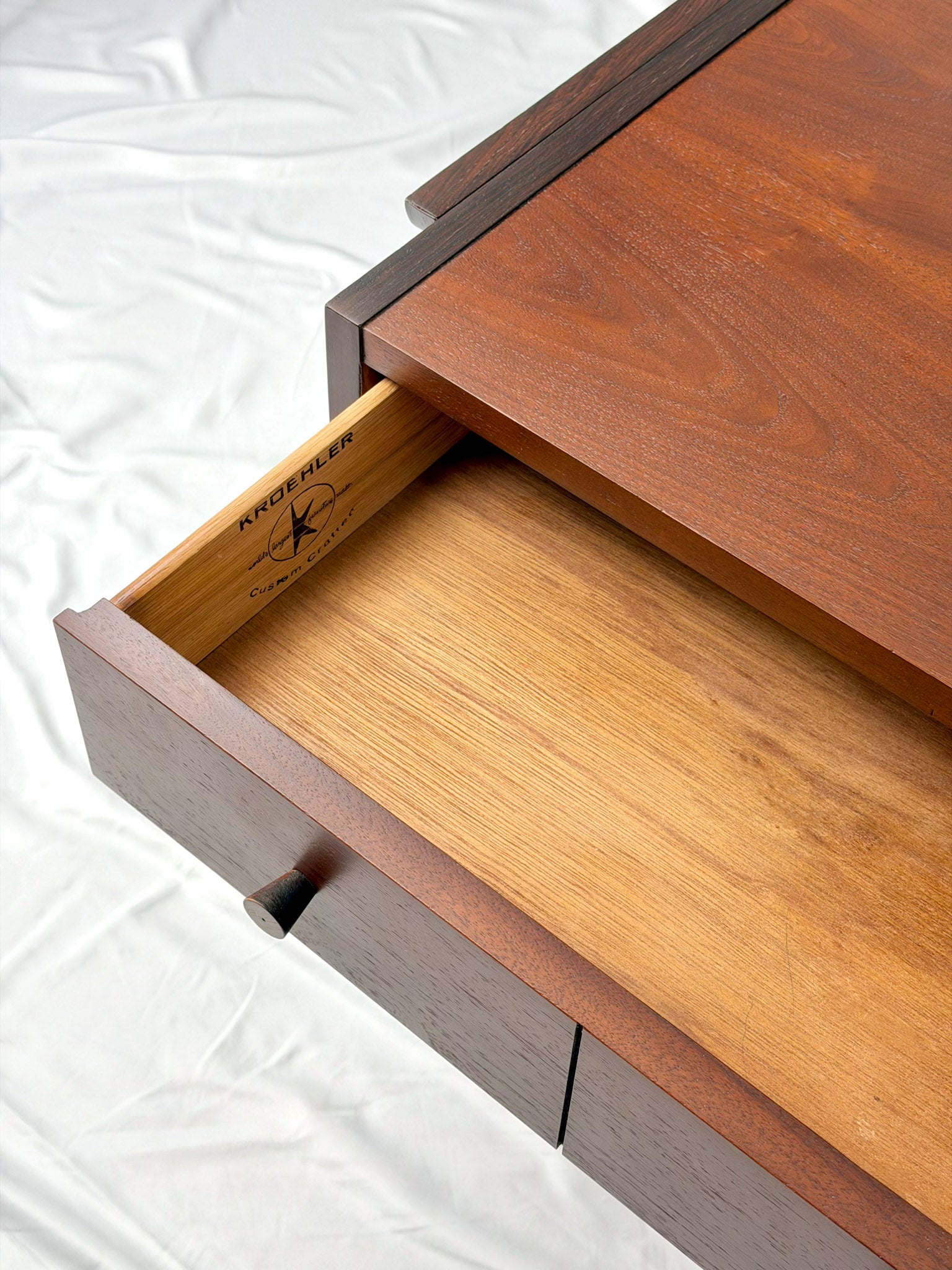 Wooden side table with drawers on a white background