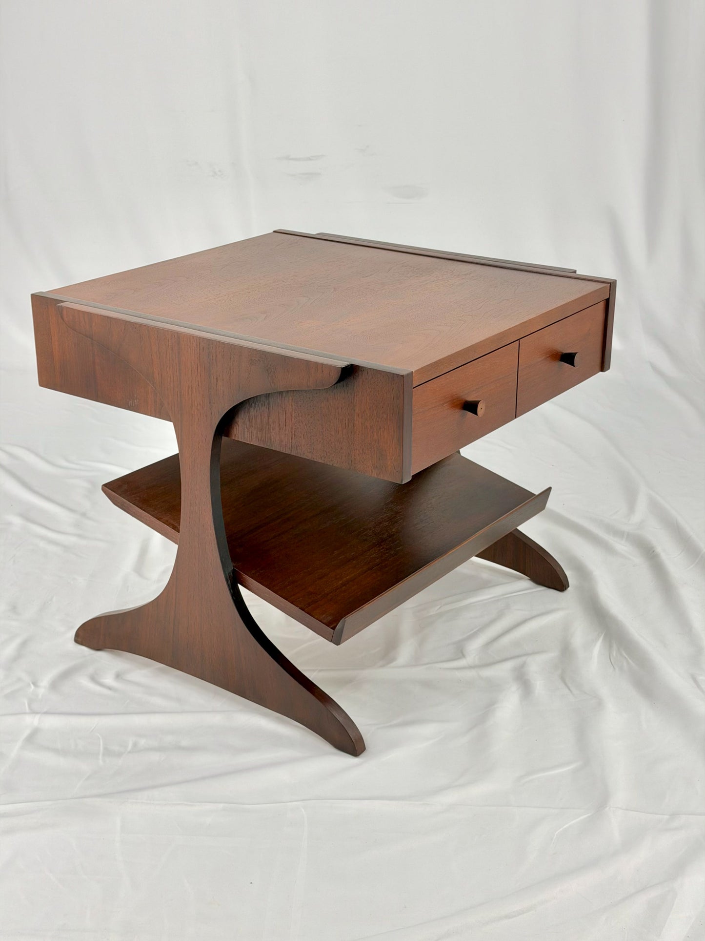 Wooden side table with drawers on a white background