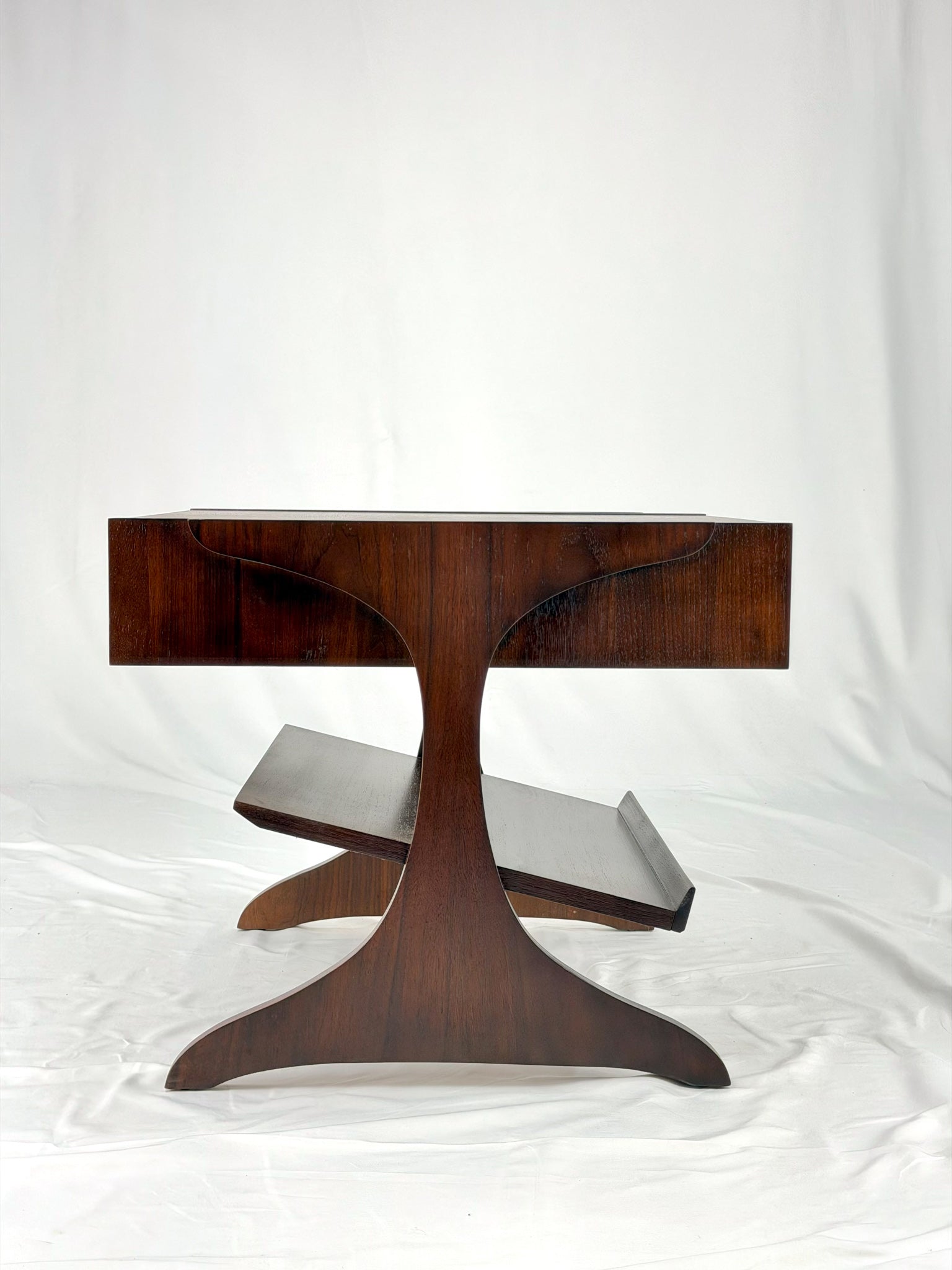 Wooden side table with a unique design on a white background