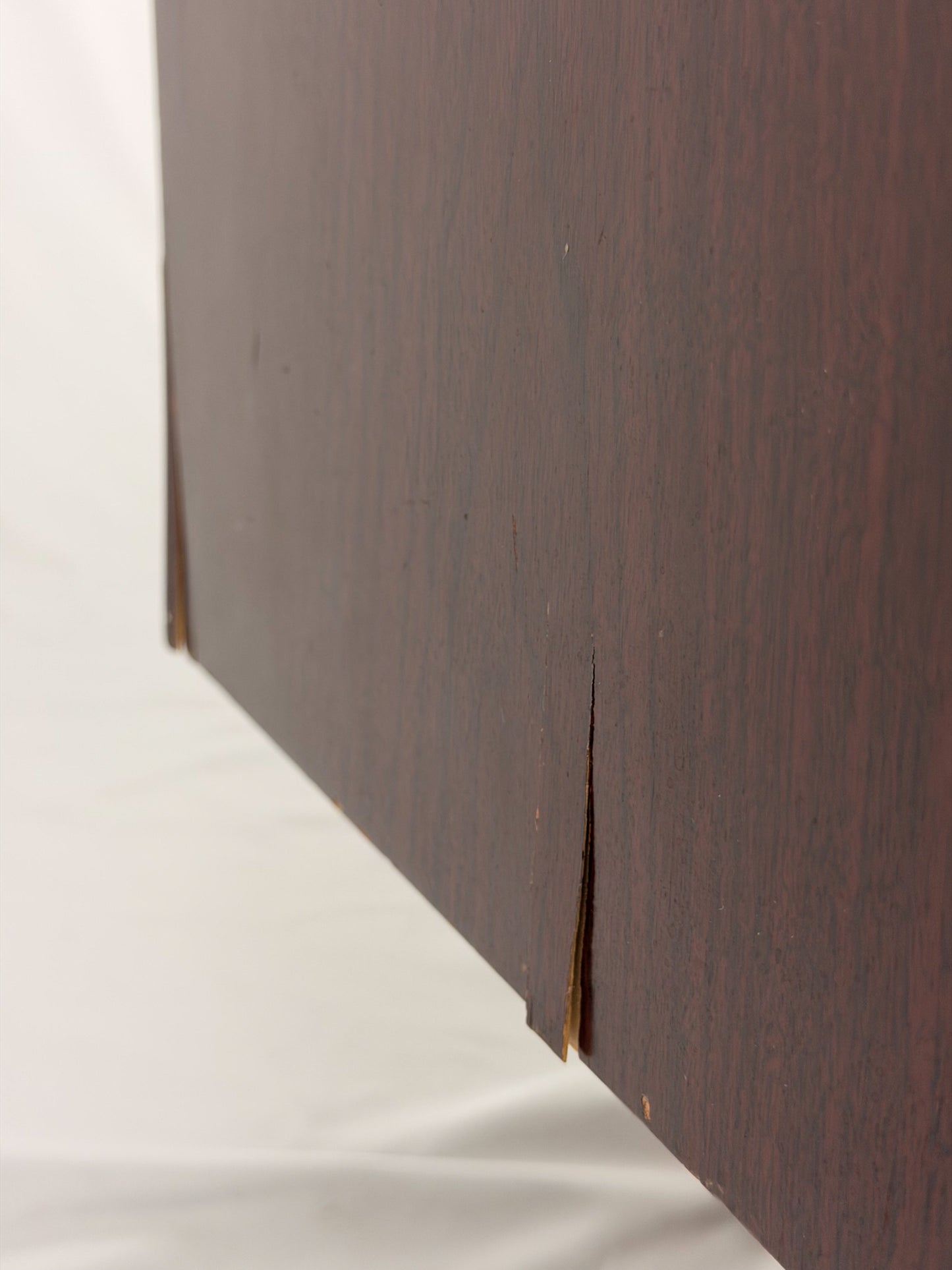 Close-up of a wooden panel with a visible grain pattern on a white background