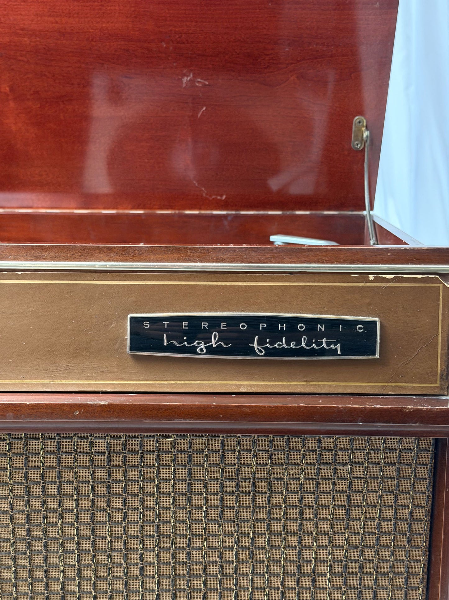 Vintage stereophonic high fidelity radio with wooden casing and metal label.