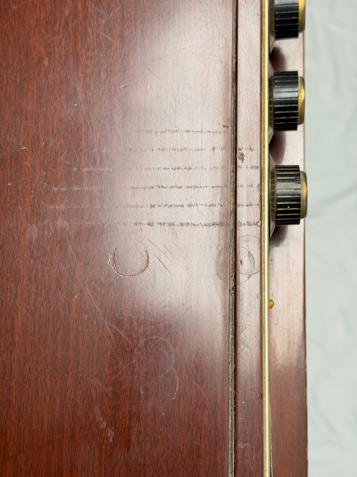 Vintage Motorola radio with wooden casing and control knobs on a white background