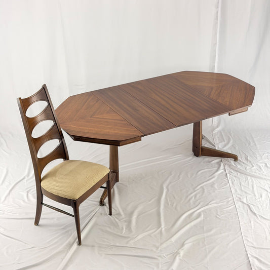 Wooden dining table with a chair on a white background