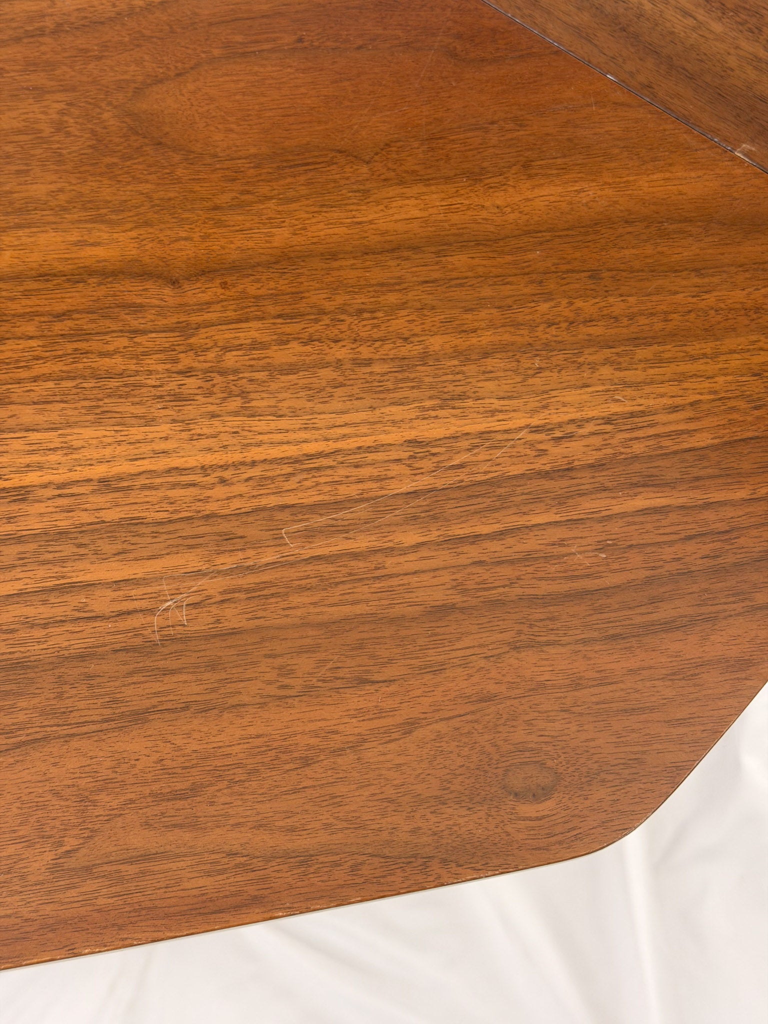 Close-up of a wooden surface with a white cloth underneath