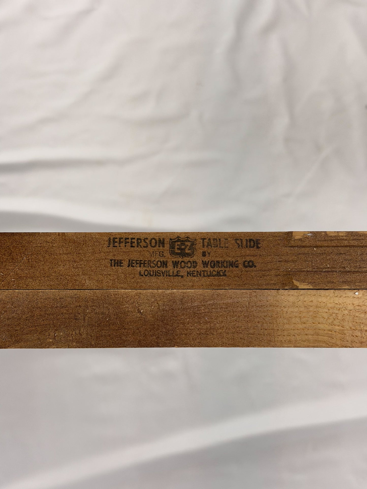 Wooden table slide with 'Jefferson Wood Working Co.' branding on a white background