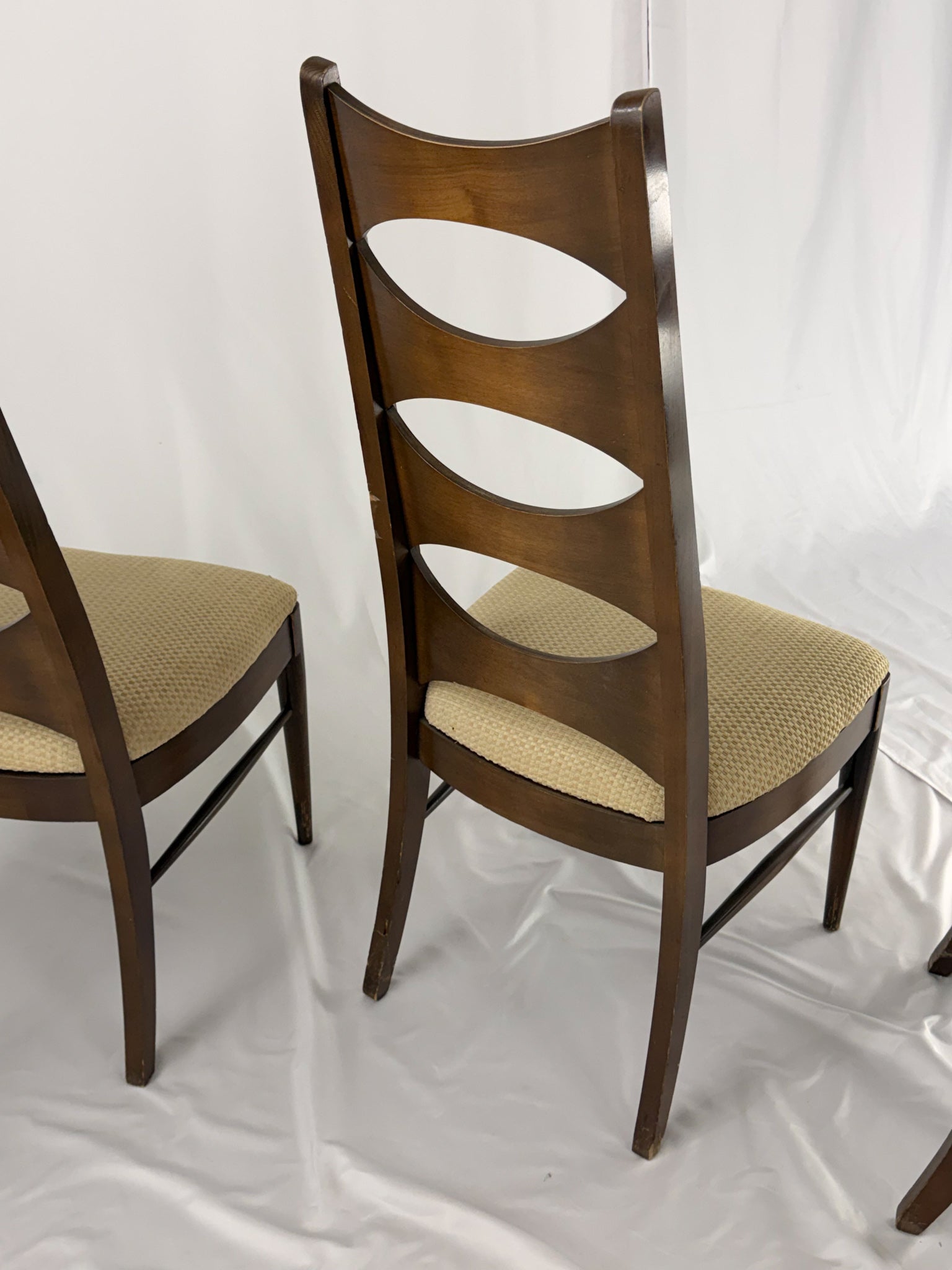 Wooden chair with a unique back design on a white background